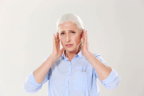 Woman experiencing tinnitus while considering homeopathic remedies